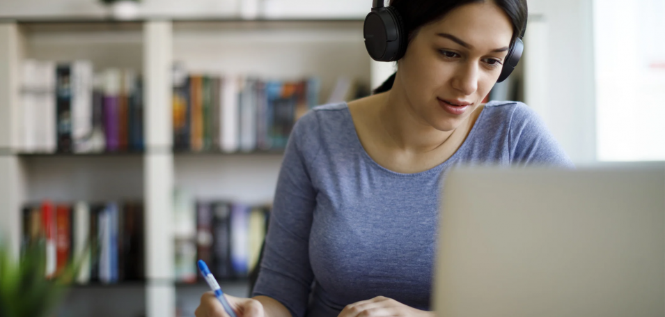 Woman in headphones on a laptop