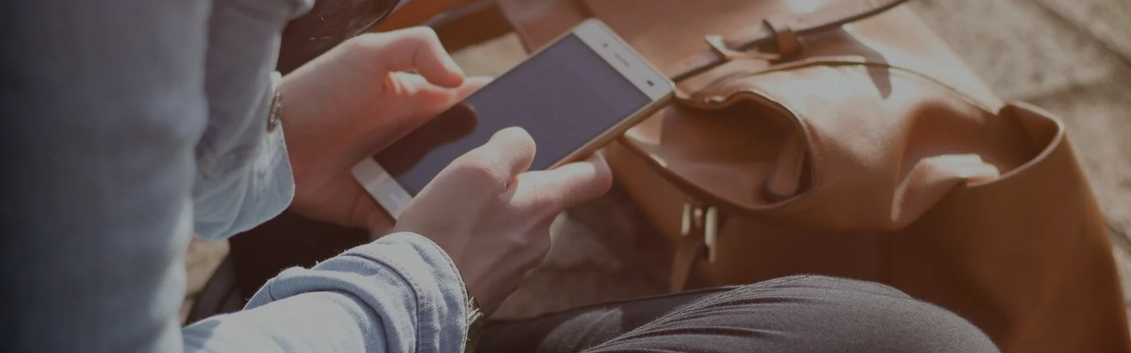 Hands typing on a smartphone