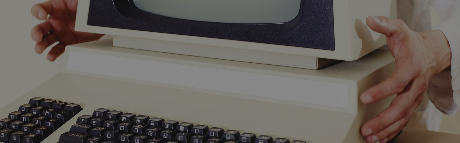 Hands holding the bottom of a computer