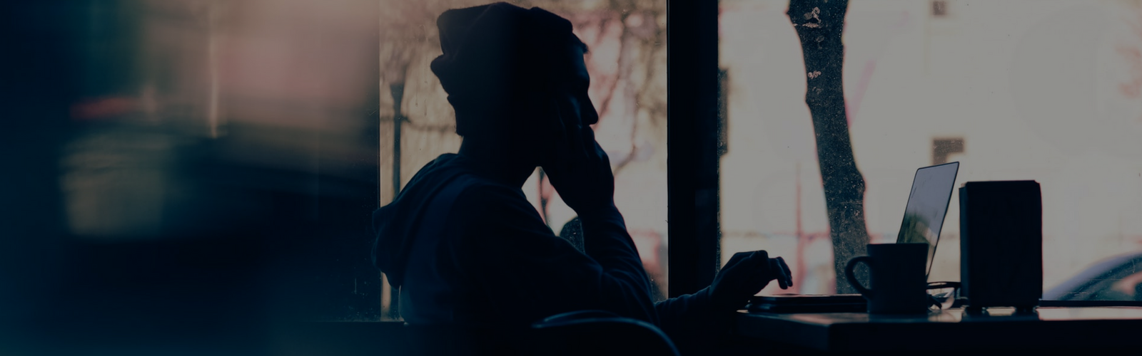 Silhouette of a person at a computer