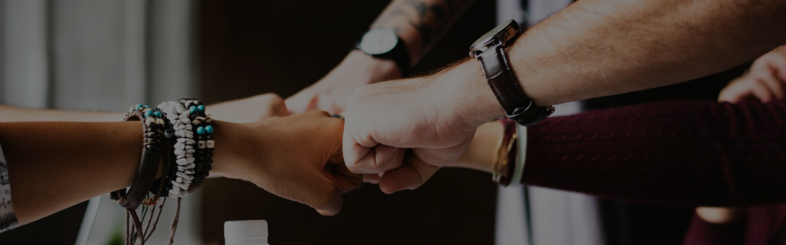 Group of people fist bumping