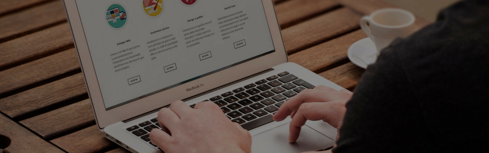 Hands typing on a laptop