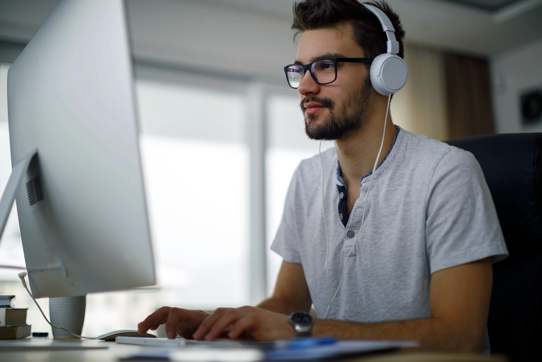 Man on desktop with headphones on