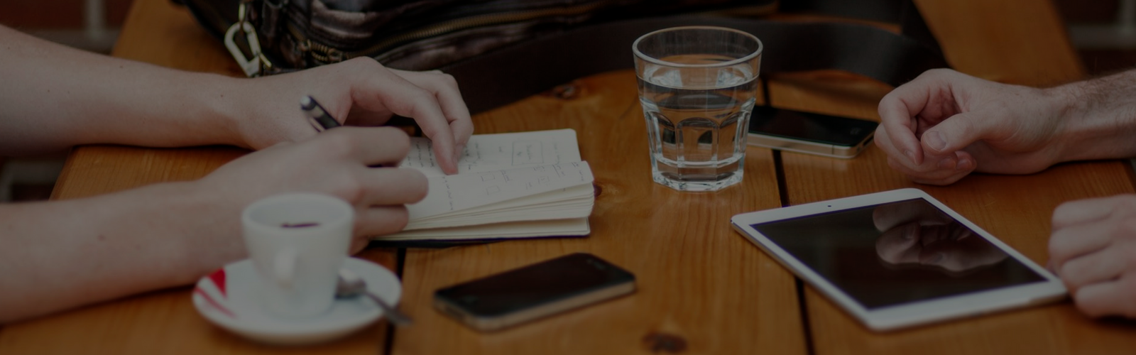 People taking notes at a table