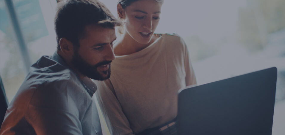 Man and woman looking at a computer